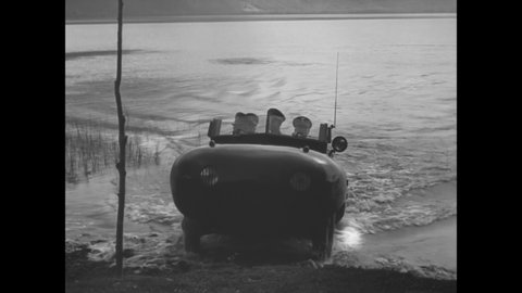 CIRCA 1938 - Italian soldiers prove the capabilities of an amphibious car by driving it across a river, and up and down outdoor stairs.