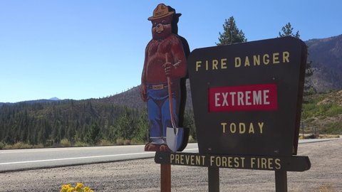 CALIFORNIA - CIRCA 2020s - A sign along a highway warns motorists that Smokey The Bear says there is extreme fire danger today.