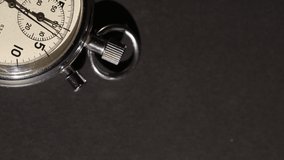 Vintage stopwatch counting seconds and minutes, on black background. Vertical video, copy space - Powered by Shutterstock - Get 15% off with code: PIKWIZARD15