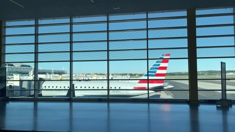 WASHINGTON DC, USA - SEPT 24, 2021: travelers walking silhouette in DCA Ronald Reagan Airport.