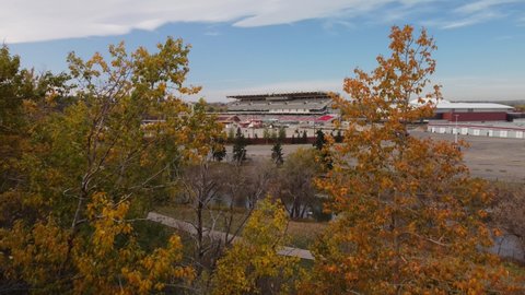 Calgary Alberta Canada, October 05 2021: Aerial shot of Stampede Park exhibition through autumn trees.