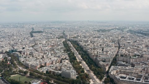 Wide slider drone shot of Arc de Triomphe and surrounding metropolitan Paris