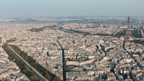 Dolly back drone shot of West Paris Eiffel tower and arc de triomphe