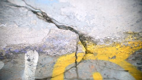 details of cracks and holes on walls and water puddles in an old Brazilian skatepark with green blue and yellow colors