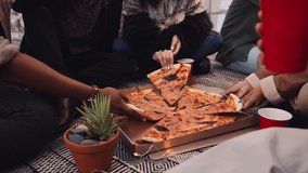 Diverse group of adult friends eating pizza and drinking on a rooftop in the evening light. High quality 4K footage - Powered by Shutterstock - Get 15% off with code: PIKWIZARD15