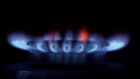 Turn on a gas burner. Kitchen cooktop, the blue flame of natural gas in close up.