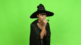 Young woman wearing witch hat is suffering with cough and feeling bad over isolated background. Green screen chroma key
