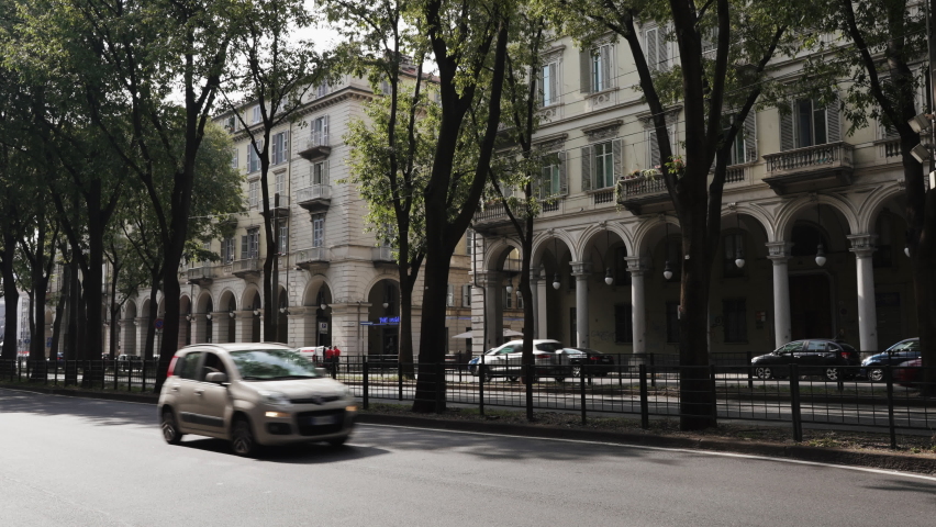 A static tripod shot showing one of the main streets of Turin in Italy. Historical buildings in background.