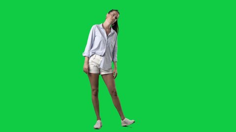 Sad or tired young stylish woman exhausted and rolling eyes. Full body on green screen chroma key background