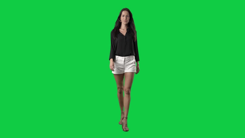 Luxury well-dressed runway fashion model walking in slow motion. Full body on green screen chroma key background Royalty-Free Stock Footage #1080375743