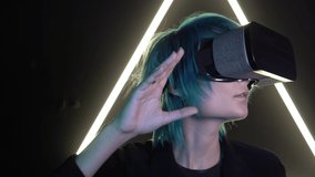 Man in virtual reality glasses on the background of neon light. Woman in VR glasses on a dark background