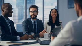 Modern Multi-Ethnic Office Conference Room Meeting: Diverse Team of Top Managers Talk, Brainstorm, Use Computers. Businessman Presenting Investment Strategy to Partners. Slow Motion Medium Close-up - Powered by Shutterstock - Get 15% off with code: PIKWIZARD15