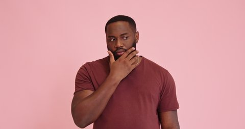 Young African american man thinking finger up gesture idea isolated on pink background