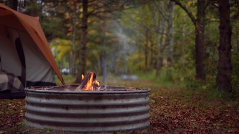closeup of campfire with tent in background Video stock
