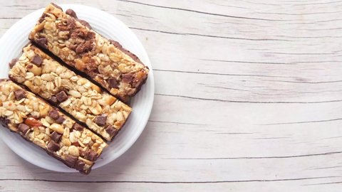 Almond , chocolate and oat protein bars on white background .