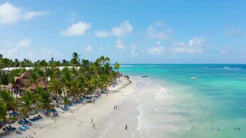 Tropical resort on paradise island landscape. Beautiful Caribbean palm beach with palms and white sand. Hotel on the shores of the Caribbean Sea. Travel to the Dominican Republic.