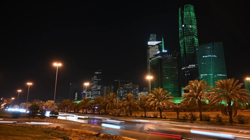 Time lapse: cityscape view overlooking King Abdullah Financial District in Riyadh city in Saudi Arabia. North ring road view and green light on the tower for the national day Royalty-Free Stock Footage #1080393647