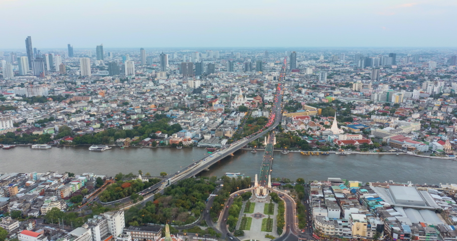 Hyperlapse aerial view day to night time lapse landmark financial business district with skyscraper over Chao Phraya River at Bangkok, Thailand at sunset. Amazing Drone Footage over the City skyline. Royalty-Free Stock Footage #1080394514