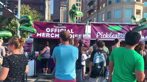Pittsburgh , Pennsylvania , United States - 08 21 2021: People are lines up to get the official merchandise of the Picklesburgh food festival