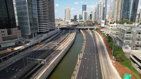  Tel Aviv, , Israel - 09 15 2021: Aerial view over the Ayalon River, in middle of the empty city of Tel Aviv, Israel - tilt, drone shot