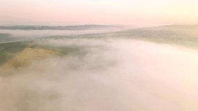 Shooting from a drone of a foggy agricultural lands. Cinematic aerial shot. Location place of Ukraine agrarian region, Europe. Ecology concept. Discover the beauty of earth. Filmed in 4k, drone video.