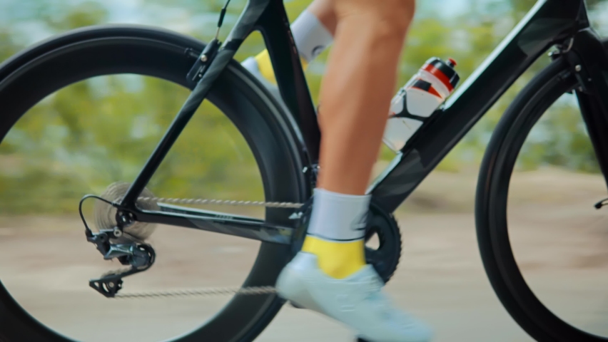 Cyclist On Bicycle Drivetrain System And Chain Rotating.Gear System 
And Bike Wheel.Cycling Drivetrain Chain Cassette And Spokes. Cyclist Pedaling Bike Endurance Exercising.Cycling Bike Wheel Rotation Royalty-Free Stock Footage #1080410582