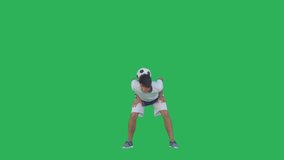 Soccer player performs tricks with the ball on a green screen background, Chroma Key. Young caucasian man practicing football skills. 4K UHD slow motion RAW graded footage
