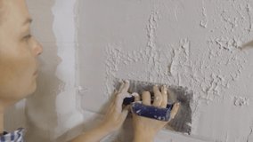 Plastering the wall. Hand holding a spatula with construction mix .Internal construction and finishing works