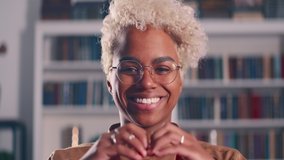 Close up portrait 25s African American woman show heart sign make symbol with hands feels grateful smile looks at camera standing indoors. Love support demonstration, volunteering, donation, good deed - Powered by Shutterstock - Get 15% off with code: PIKWIZARD15