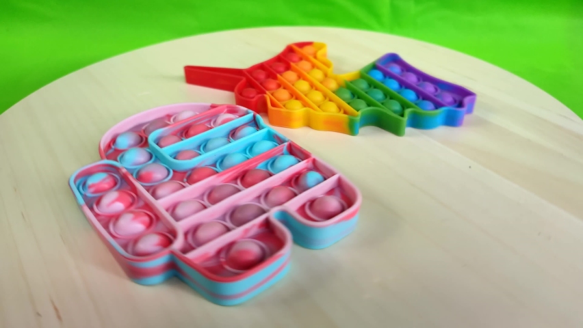 Popit, the newest trending toy for children, colorful pops with unicorn motifs and andorid motifs rotating beautifully on the turntable,