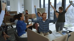 Happy businesspeople receiving good news in start up office. Excited business people enjoy success. Successful startup marketing agency. Multi ethnic team celebrating victory in open space coworking - Powered by Shutterstock - Get 15% off with code: PIKWIZARD15