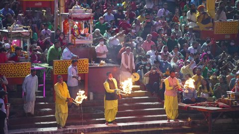 Haridwar, Uttarakhand.India- March 05, 2021- Ganga Arti visuals from Indian largest gathering festival Maha Kumbh, Haridwar, India. Pilgrims taking blessings from lightning candles (Arti). Worshipping