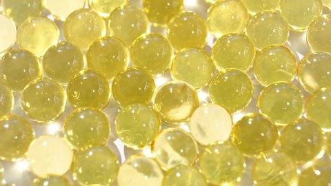 soft yellow gelatine capsules. close-up. pharmaceutical production. business concept. vitamin d. dietary supplement for the whole family. fish oil