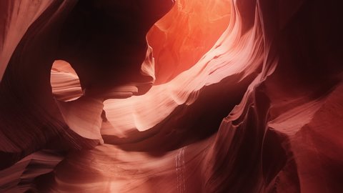 Cinematic footage red wavy pattern nature background from world famous landmark Antelope canyon in Arizona nature park, USA travel concept. Beautiful smooth wavy texture orange sandstone walls