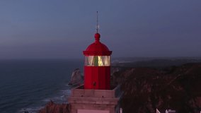 The Cabo da Roca Lighthouse, Sintra, Portugal, Europe. Calm and magical sunset at the picturesque cape. Aerial footage of breathtaking natural scenery with operating beacon. High quality 4k footage