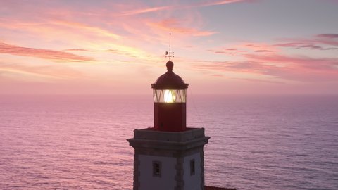 The Cabo da Roca Lighthouse, Sintra, Portugal, Europe. Calm and magical sunset at the picturesque cape. Aerial footage of breathtaking natural scenery with operating beacon. High quality 4k footage