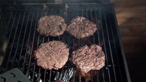 Cooking meat over a fire. Grill rack. The flame is grilling hamburger patties.