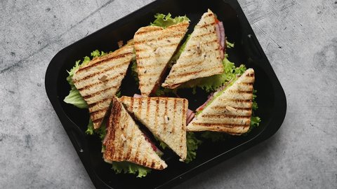Appetizing fresh grilled club sandwiches with ham and cheese