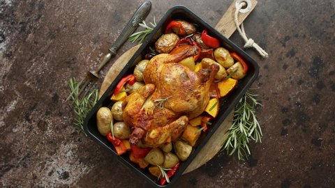 Delicious whole chicken cooked with pumpkin, pepper and potatoes. Served in metal baking pan.