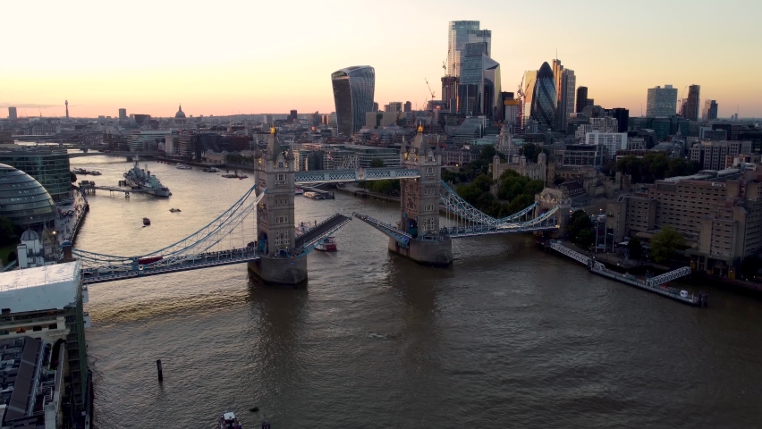 Aerial sunset view to the lifted Tower Bridge and skyline of the financial district City of London, Unuted Kingdom | Shutterstock HD Video #1080435941
