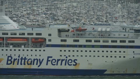 Portsmouth, Hants, UK-10-08-2021: Normandie, a Brittany Ferries passenger and car transport between Portsmouth Harbour and Caen in France, arrives on the Solent carrying 2,123 passengers and 600 cars.