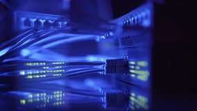 Close up fiber optic in server room. Network cables installed in the rack at data center. Ethernet cable on network switches background - Powered by Shutterstock - Get 15% off with code: PIKWIZARD15