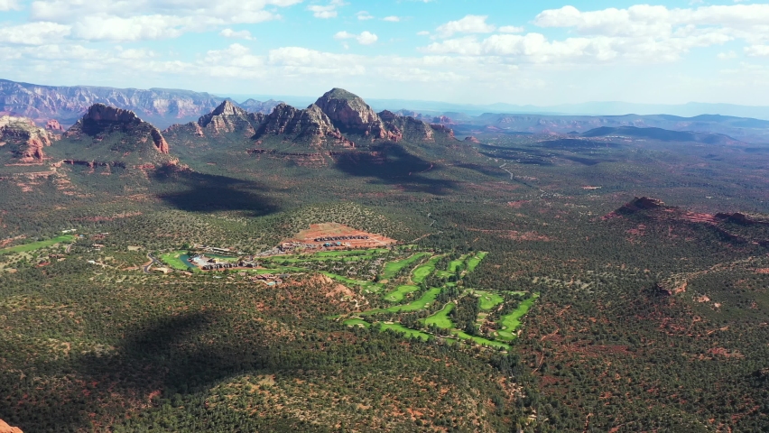 Breathtaking Landscape of Sedona, Arizona USA. Aerial View of Green Valley Under Red Sandstone Hills on Sunny Day, Drone Shot