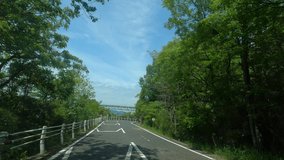 Scenery of the blue sky sea and a big bridge. (In-vehicle video)