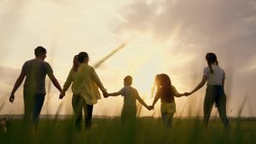 Big happy family. Summer people in park at sunset. Family is walk on green grass in natural park. Family fun, joy in nature. Healthy young family at sunset. Concept of happy people in nature in grass - Powered by Shutterstock - Get 15% off with code: PIKWIZARD15