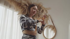 Portrait of unhappy pretty sporty fit woman with hands tied with measuring tape trying to free of constant worry and obsession of weight gaining , expressing determination in domestic room. - Powered by Shutterstock - Get 15% off with code: PIKWIZARD15