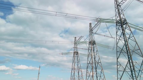 Survey of high-voltage power lines by a quadrocopter. High Voltage Electricity Transmission Pylon.Power Lines Supply With Wire.High Voltage Electric Tower With Insulators.