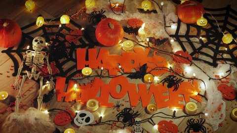 Scary halloween decorations. Preparation for Halloween party. Horror scary halloween night party. Decorations for halloween, spiders, pumpkins, skeleton and burning candles in night room