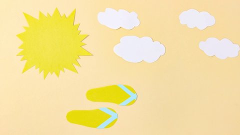 Stop motion animation. Paper sun and clouds, beach flip-flops run nearby. Summer cartoon. Top view.