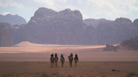 WADI RUM, JORDAN - 27TH DECEMBER 2018: Bedouins and camels in the desert Wadi rum, Jordan